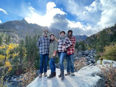 four people on boulder in wildnerness